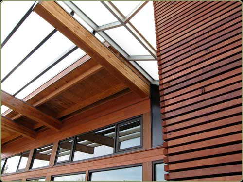 redwood siding, glass and concrete walls.
